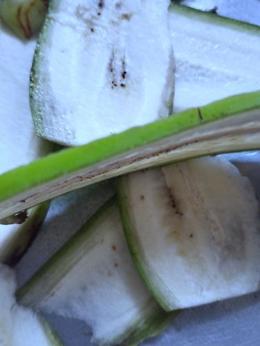 Step 1.2: Peel the raw banana slightly and slice them into medium-thick slices
