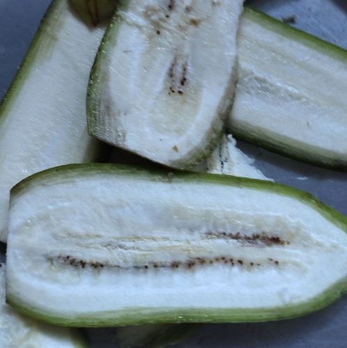 Step 1.1: Peel the raw banana slightly and slice them into medium-thick slices