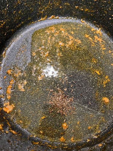Step 4.1: In the same kadai, heat oil and temper with cumin seeds