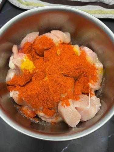 Step 1.1: Add salt, turmeric, red chilli powder, ginger-garlic paste, and squeeze in half a lemon