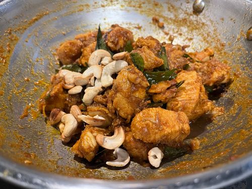 Step 6.1: Fry cashews until golden brown and pour this tempering over the chicken fry