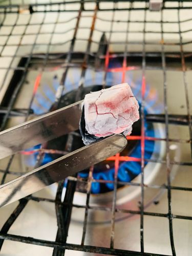 Step 2.1: Heat a piece of coal until red hot, place it on the foil, drizzle with a teaspoon of oil, and immediately cover the bowl with a tight lid