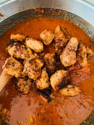 Step 5.1: Add the grilled chicken tikka along with the reserved marinade to the simmering gravy