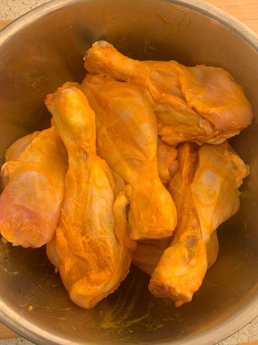 Step 1.2: In a large bowl, mix the chicken legs with turmeric, salt, and lemon juice
