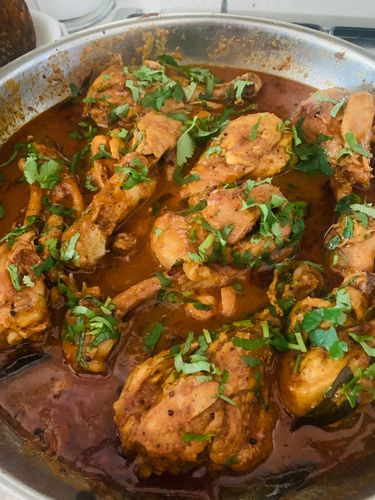 Step 6.1: Garnish with chopped coriander leaves and serve hot with rice or roti