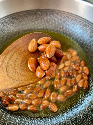 Step 2.1: In the same pan, lightly roast the almonds for 1–2 minutes until fragrant