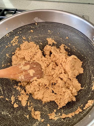 Step 4.3: In the same pan, add the whole wheat flour (atta) and semolina (sooji)