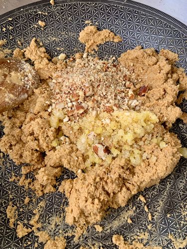 Step 5.1: Add the ground gond-almond mixture to the roasted flours, along with 2 more tablespoons of ghee